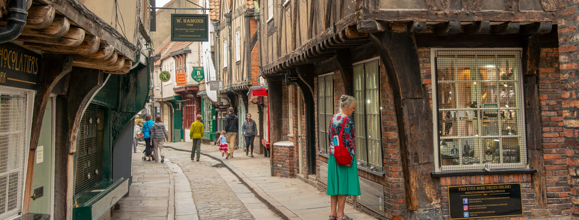 picturesque small medieval shopping street lined by crooked overhanging timber-framed buildings
